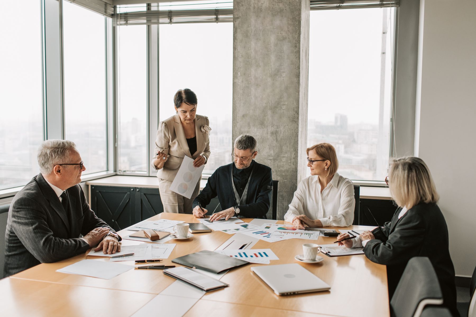 Business professionals reviewing documents together during a meeting in a modern office