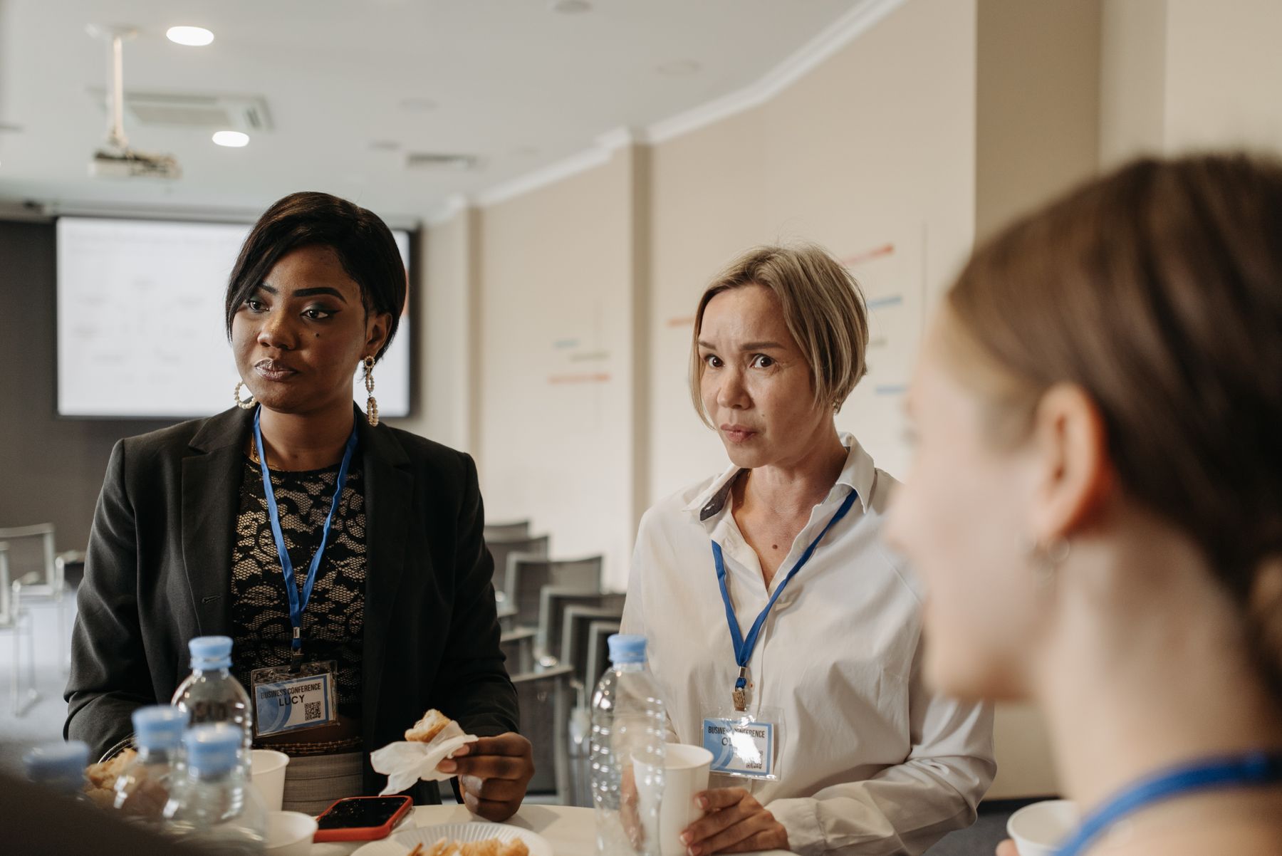 Professionals networking and speaking together during a conference event
