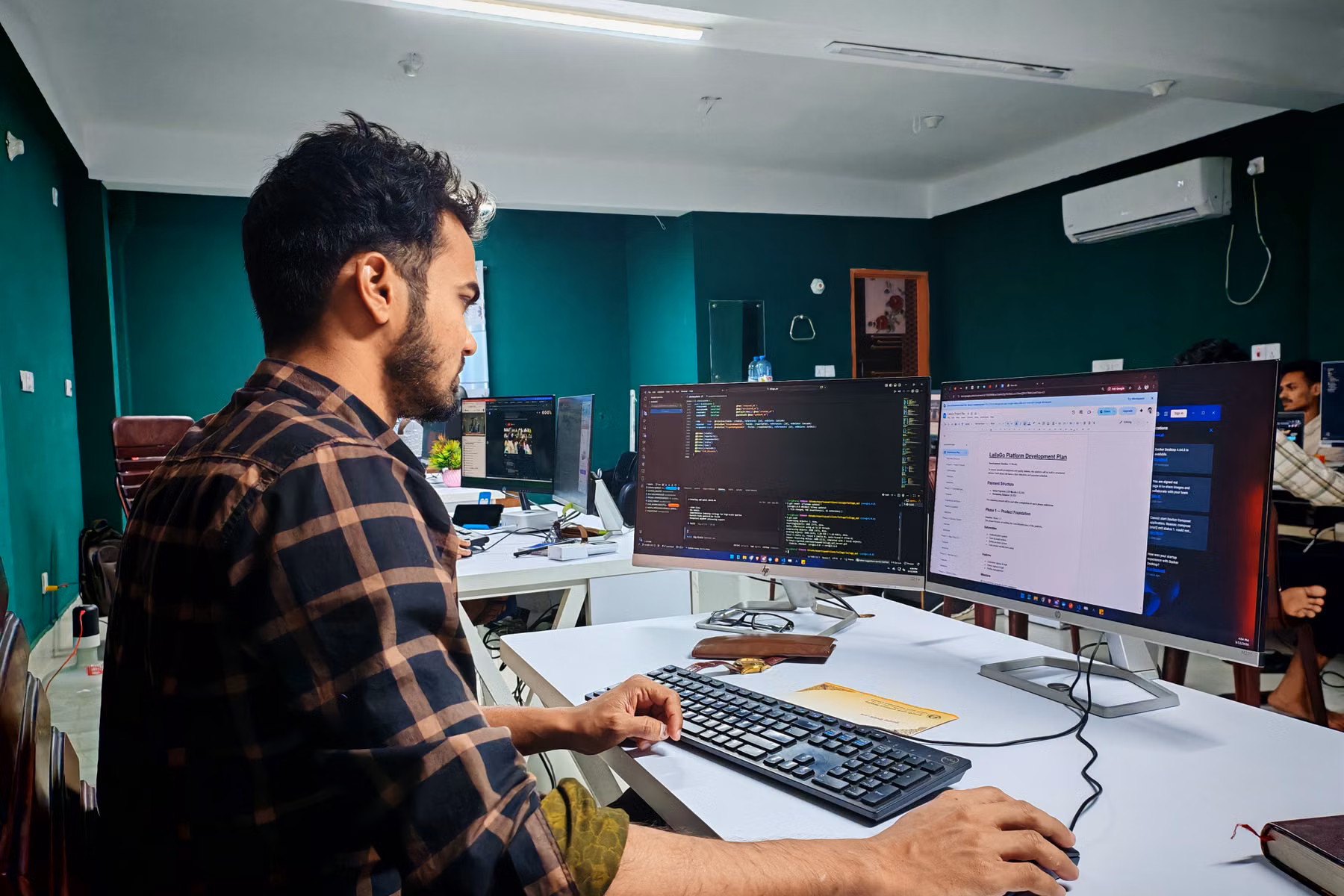 Software developer working in a modern office representing AI embedded into business workflows