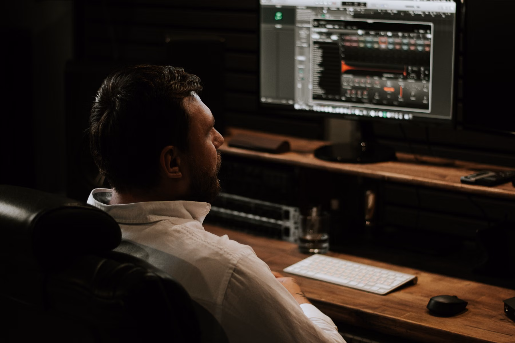 Professional working with software on multiple monitors representing custom applications and SaaS evaluation
