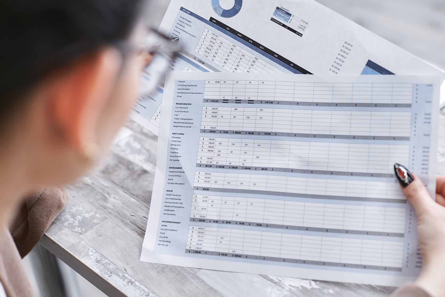 Business professional reviewing financial spreadsheets and reports while evaluating whether current accounting systems still fit