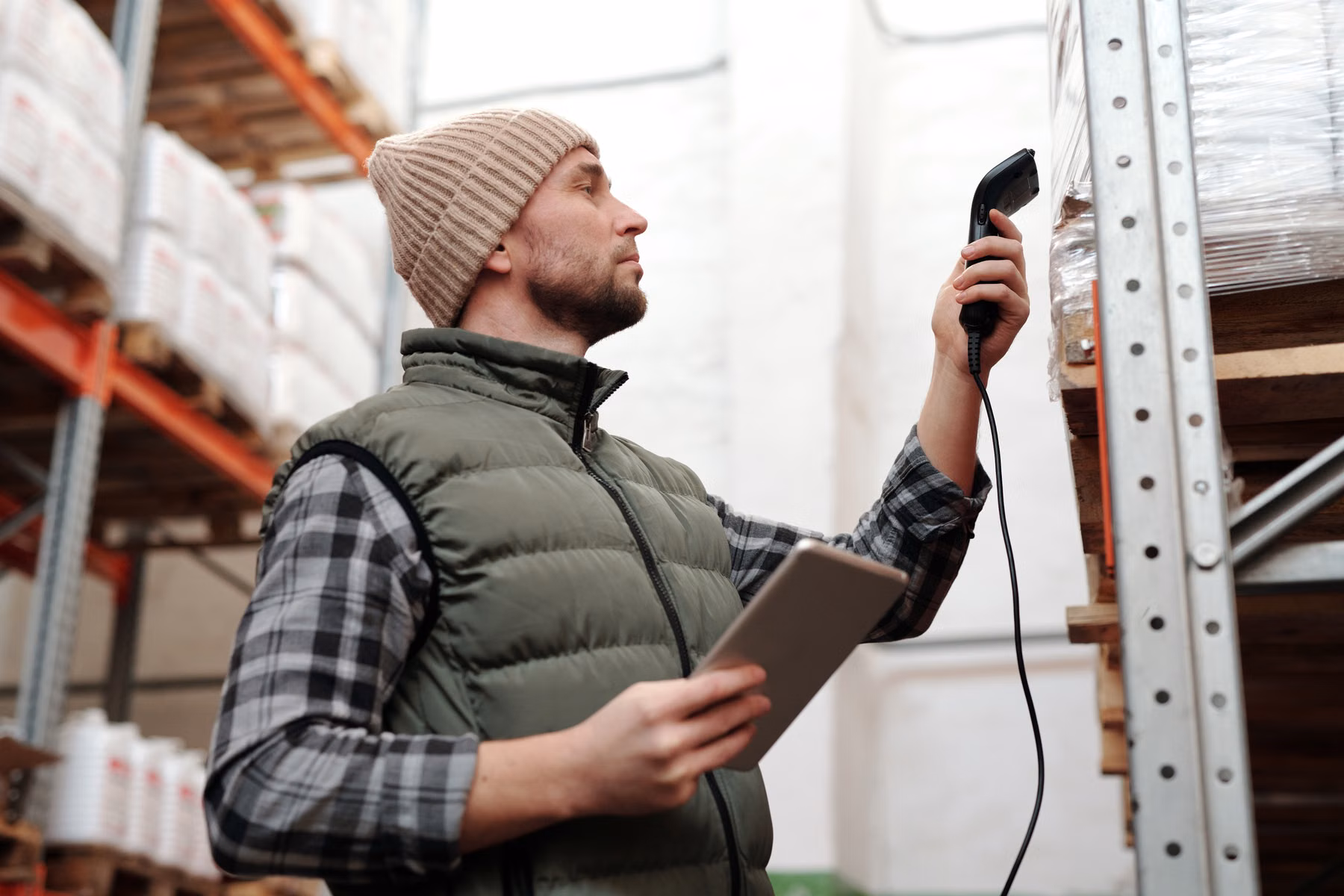 Warehouse employee using a handheld barcode scanner
