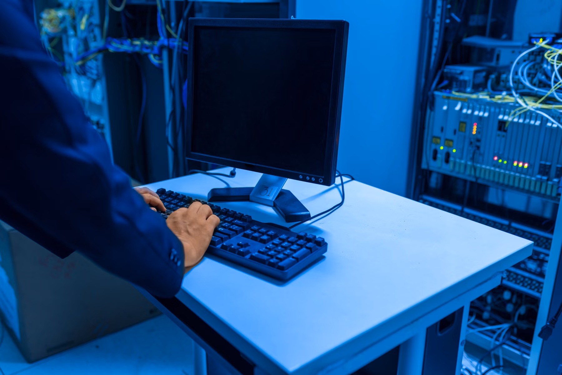 IT technician working in a modern data center server room
