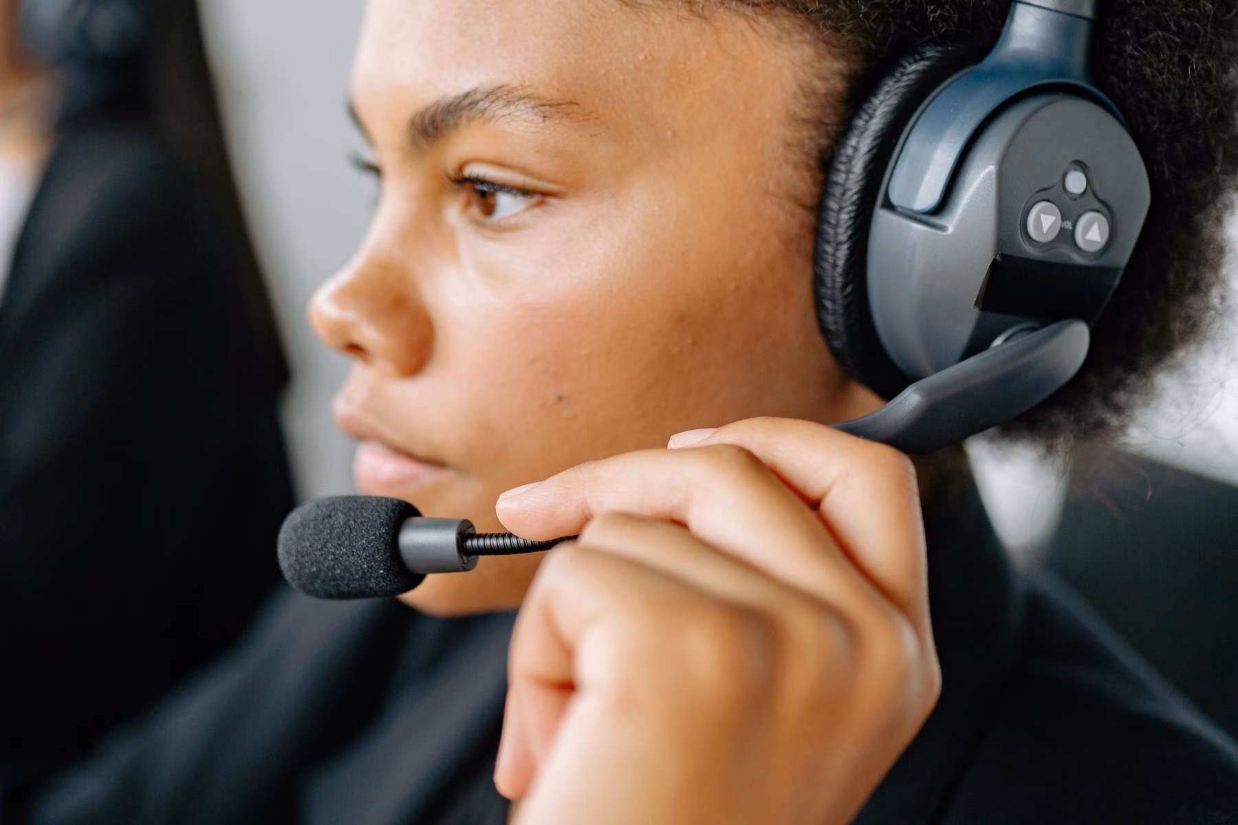 Customer support professional wearing a headset in a modern office